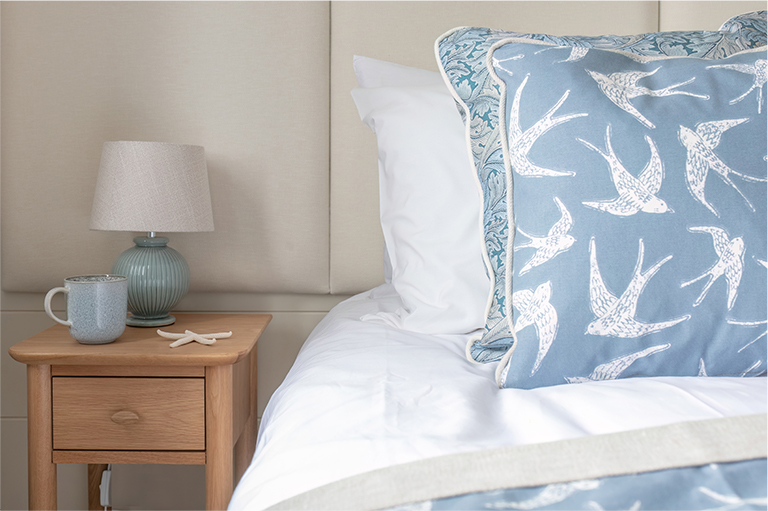 Beautiful fabrics adding warmth and texture to the second bedroom in The Peregrine luxury lodge.