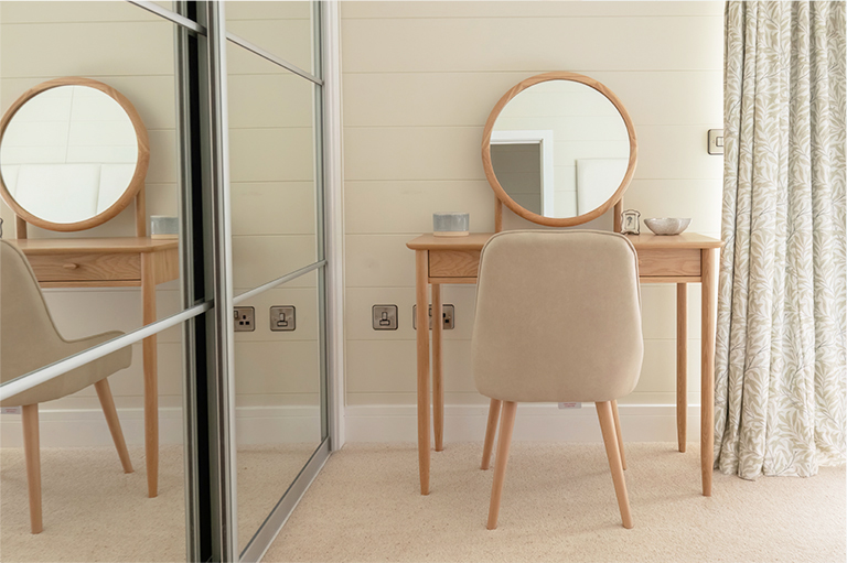 Contemporary dressing table with elegant accessories in The Peregrine master bedroom.