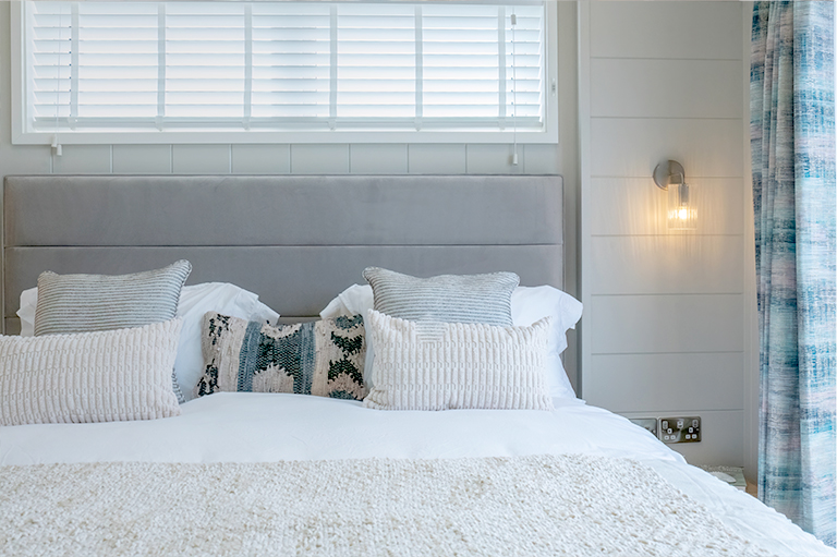 The Shearwater master bedroom featuring stylish coastal-inspired interiors and a calming colour palette.