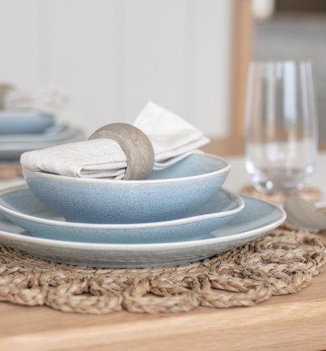 Beautifully presented dining table with coastal-inspired table settings and natural textures.